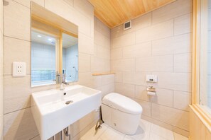 A modern bathroom with a white sink, a toilet, and a mirror. - KYOTO ZEN HOUSE (Kyoto)