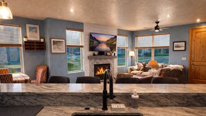 A modern kitchen with a marble countertop, a built-in stove, and a sink. - 5 minute walk to shops! Great Location and private garage (Park City)
