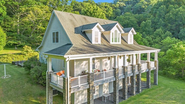 A house with a porch, a covered deck, and a stone foundation. - Sullivan Farm at Helton Creek - Fire Pit - Foosball - Fireplace (Lansing)