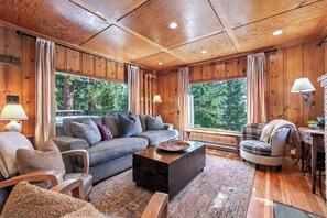 A cozy living room with a sofa, armchairs, and a coffee table.