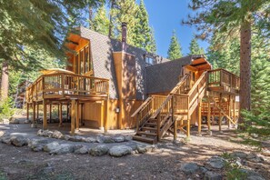 A cabin with multiple wooden decks and staircases, surrounded by trees. - Short Drive to the Beach, Hot Tub, Large Deck - All Decked Out (Carnelian Bay)