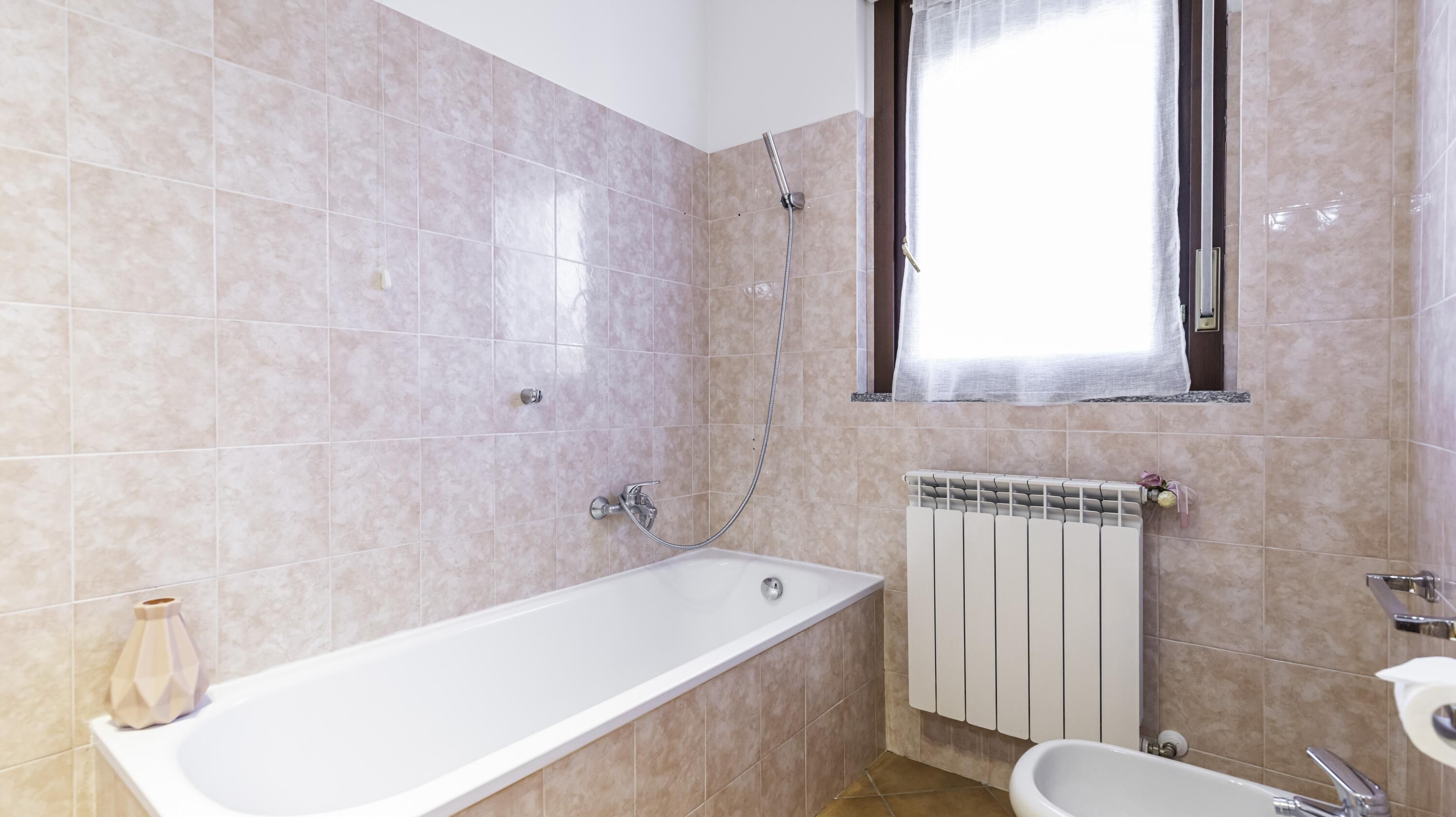 A bathroom with a bathtub, a shower, and a toilet.