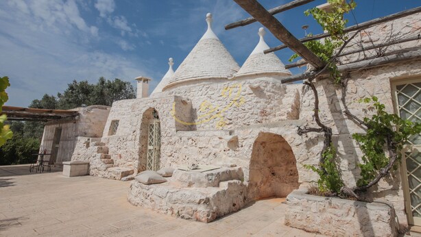Um edifício de pedra com telhados em forma de cone e uma porta pequena.