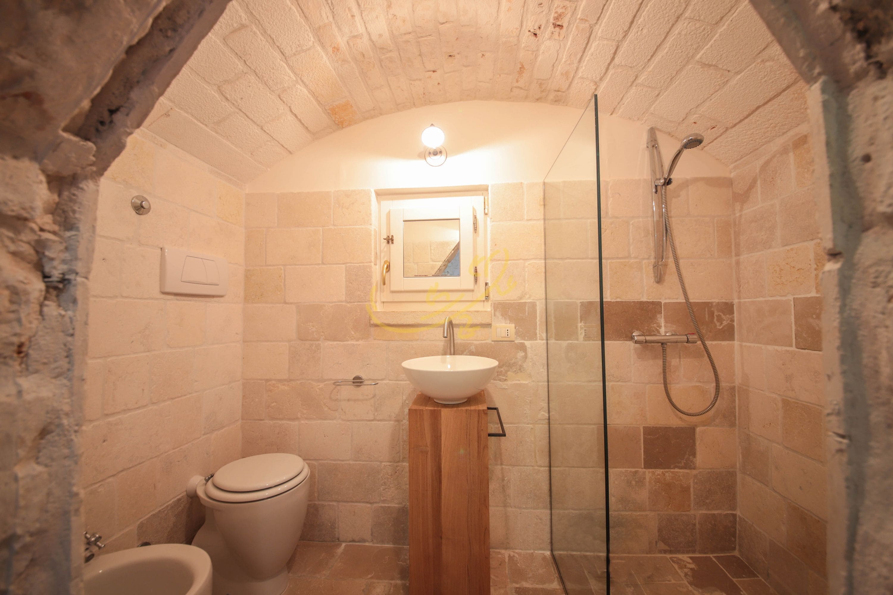 A bathroom with a white sink, a toilet, and a shower.