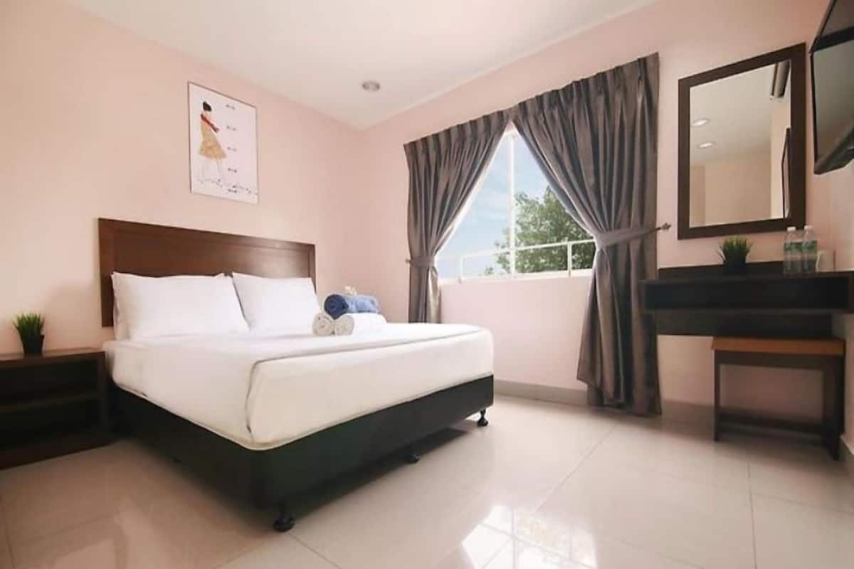 A hotel room with a bed, a nightstand, a desk, a mirror, and a window with curtains.