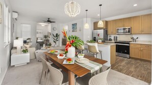 A modern kitchen with wooden cabinets, a microwave, and a built-in oven.