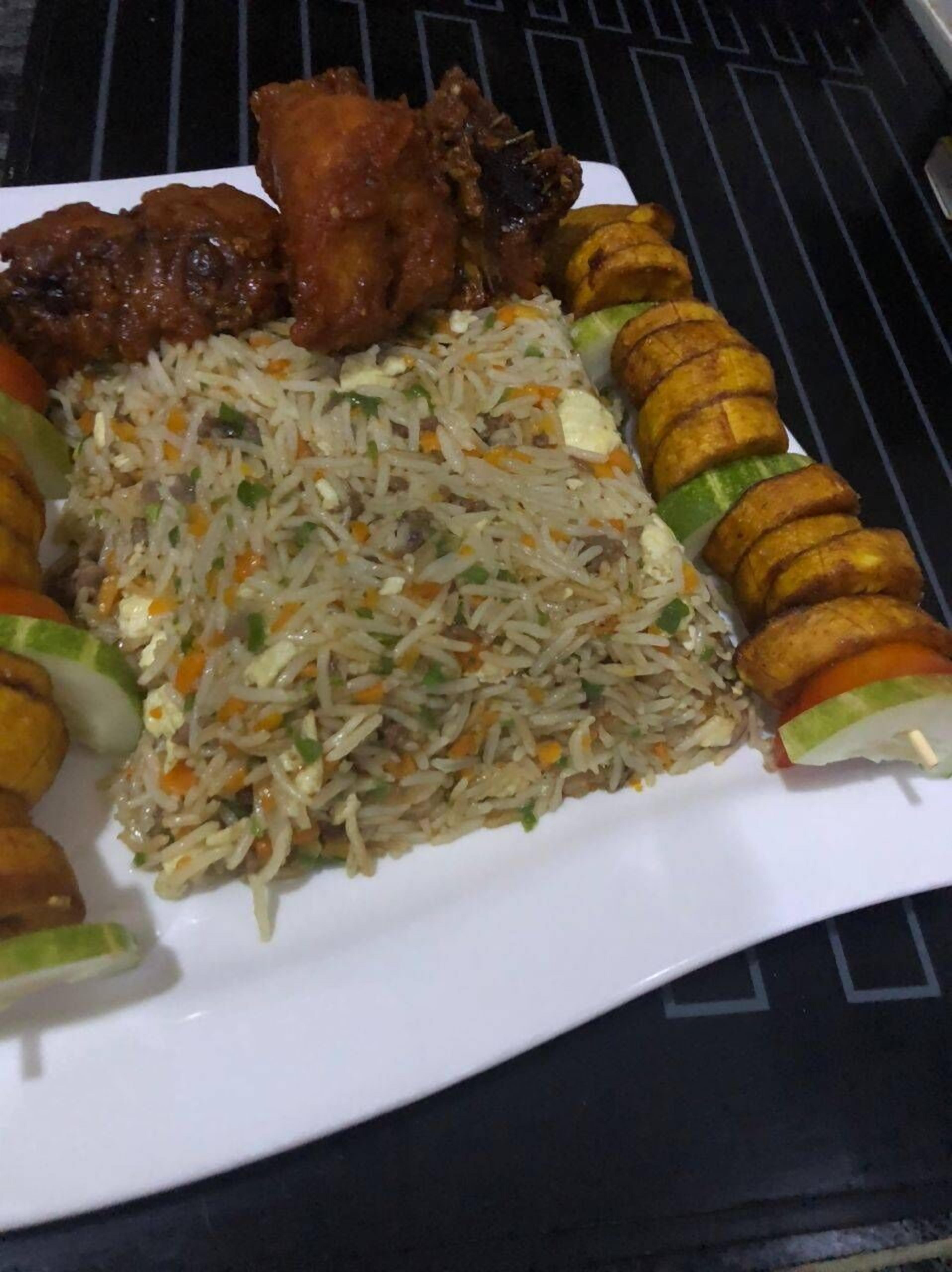 A plate of food with rice, vegetables, and fried items.