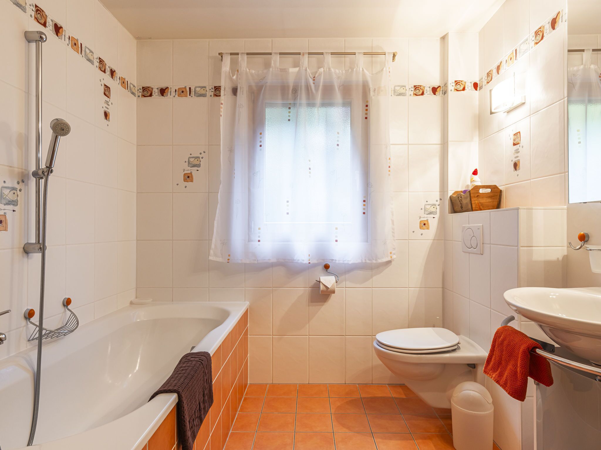 A bathroom with a bathtub, toilet, and sink.