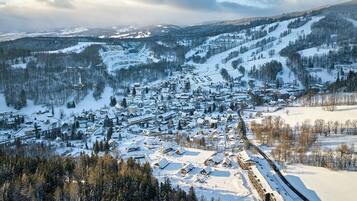 Un village enneigé, avec des bâtiments et une piste de ski.