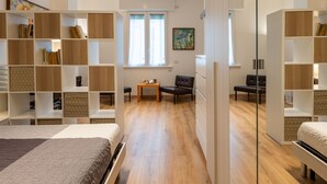 A modern, well-lit room with a bed, a desk, and a bookshelf. - Contarini by Interhome (Milan)