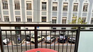 A balcony with a red table, two cups, and an open book. - Contarini by Interhome (Milan)