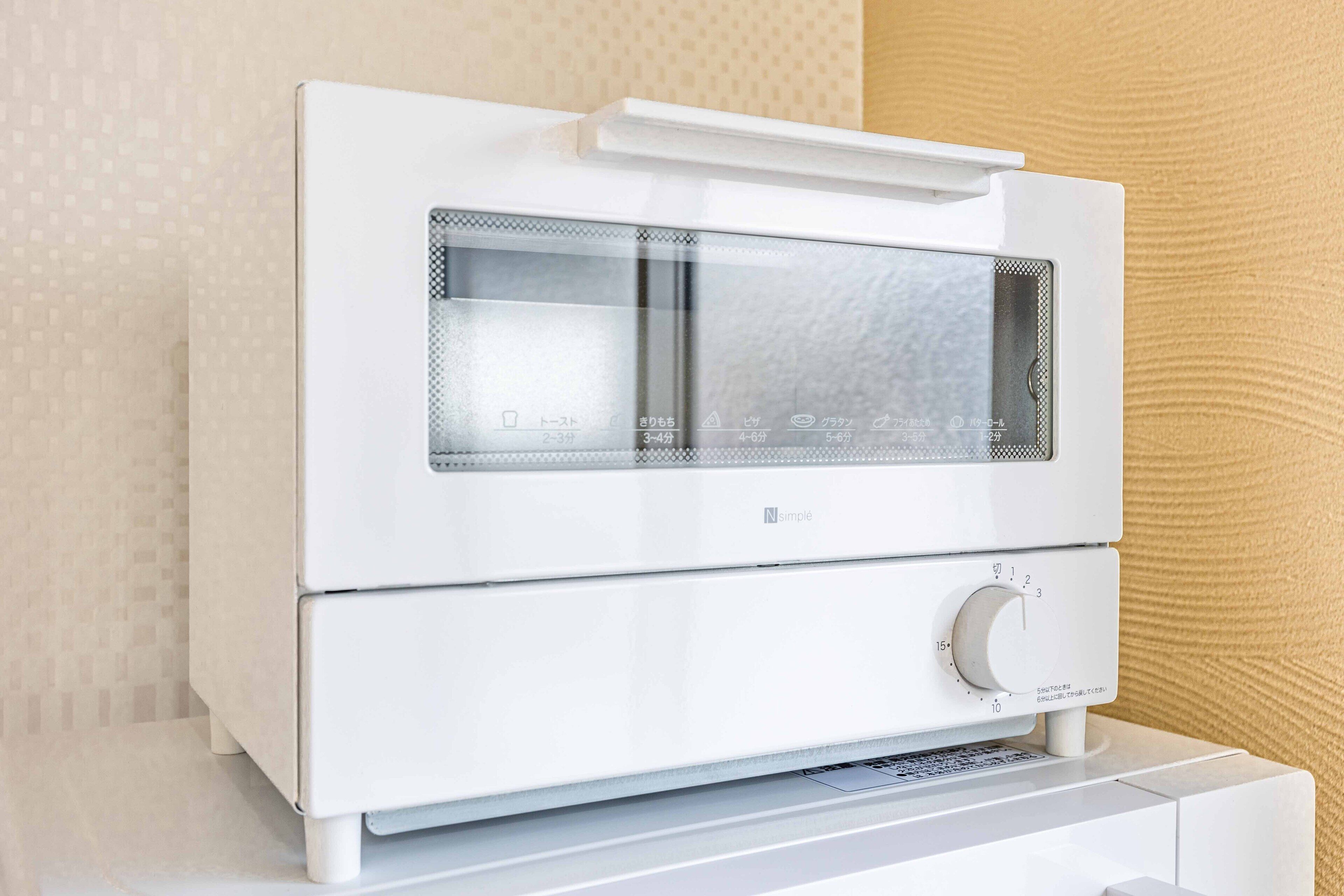 A white, modern-looking device with a control panel and a display screen, likely a piece of electronic equipment.
