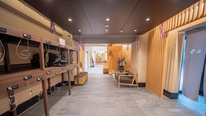 A hotel lobby with a reception desk, seating area, and a staircase leading to the upper floors. - Hiyori Residence Kyoto Kamogawa (Kyoto)