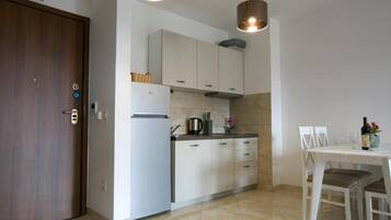 Family Apartment | Private kitchen | Fridge, stovetop, electric kettle, toaster