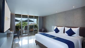 A modern hotel room with a large bed, a desk, and a television.