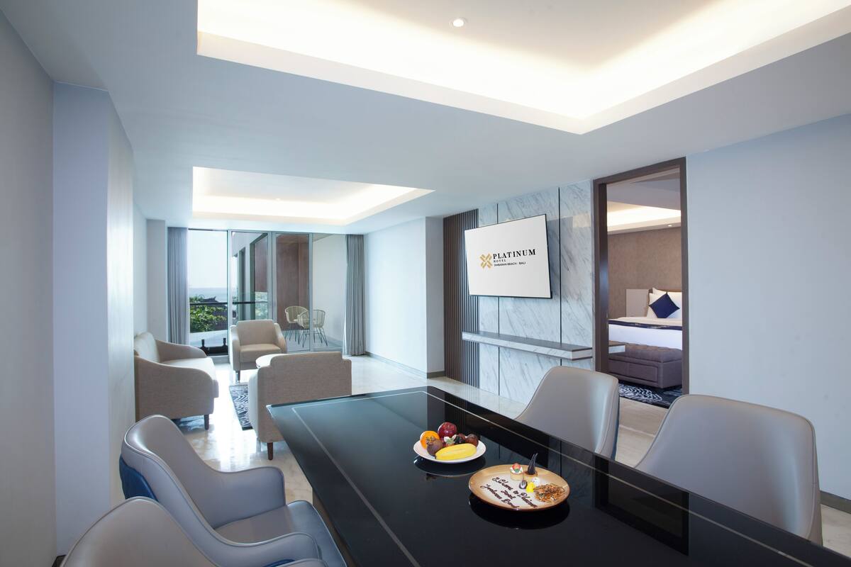 A modern conference room with a glass table, seating, and a sign reading "PLATINUM".