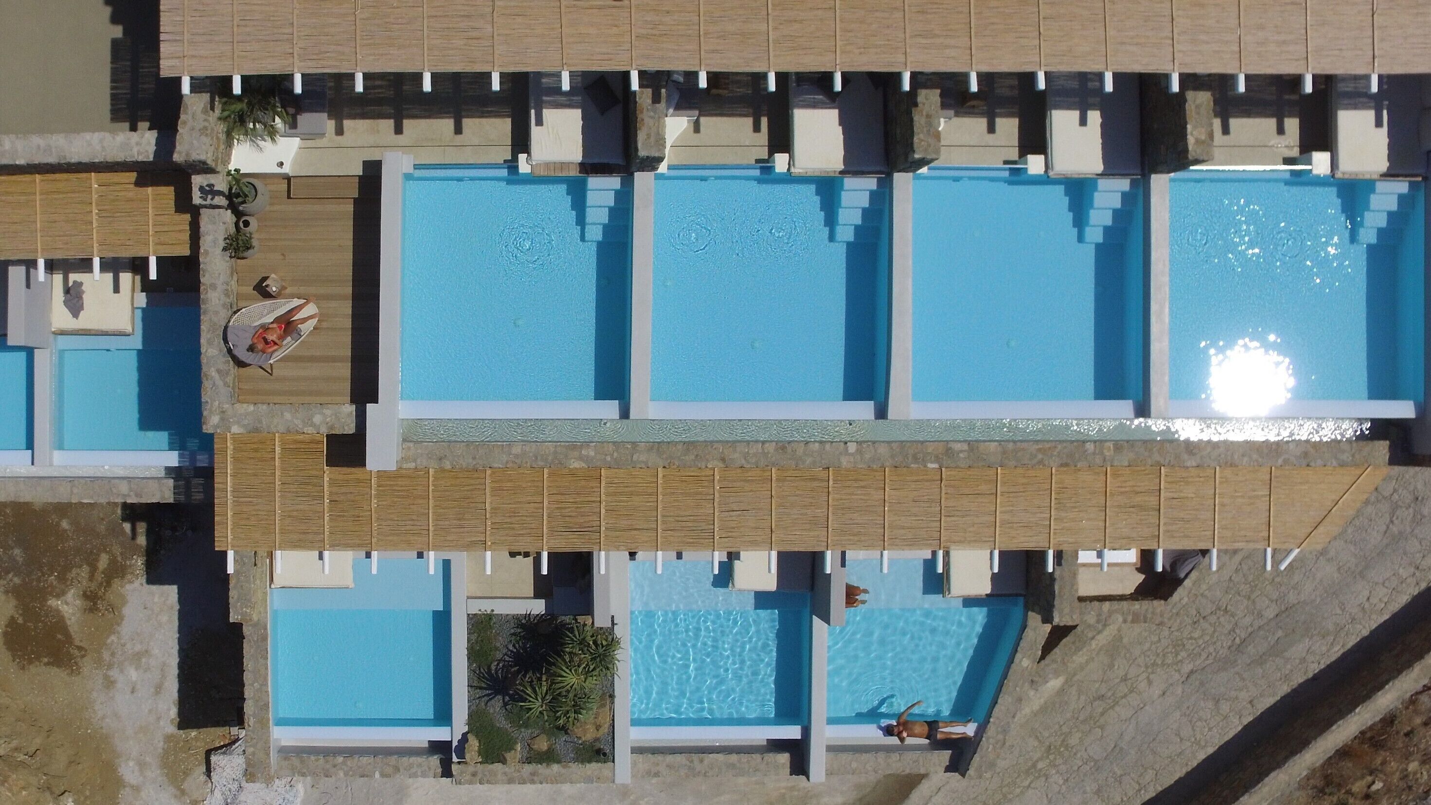 An aerial view of a resort with multiple swimming pools, arranged in a grid pattern.