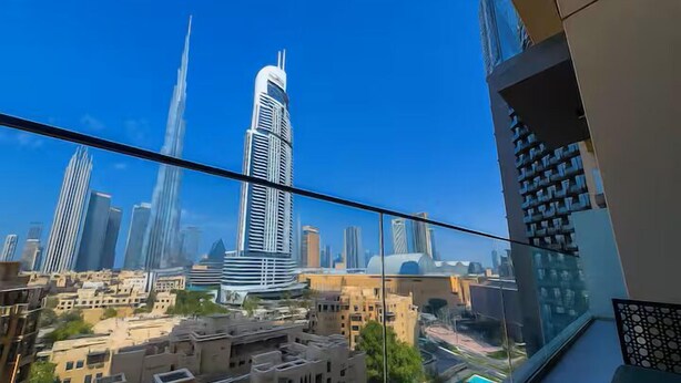 A high-rise building with a modern design, featuring a prominent tower and a curved facade. - Vogue| in Heart of Downtown with Burj Khalifa view (Dubai)