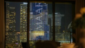 A nighttime cityscape with illuminated buildings, including a prominent Emaar skyscraper. - Vogue| in Heart of Downtown with Burj Khalifa view (Dubai)
