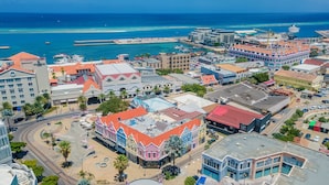 A coastal town with a mix of historic and modern buildings, a marina, and a prominent pier. - Dutch Caribbean Residence B (Oranjestad)