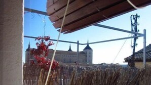 A view of a traditional building with a wooden fence and a clear sky.