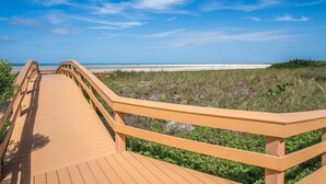 A wooden boardwalk leading to a beach with a clear sky. - Beachfront 1BR condo on Marco Island with pool, WiFi, and kitchen (Marco Island)