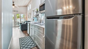 A modern kitchen with stainless steel appliances, a built-in oven, and a countertop with a sink.