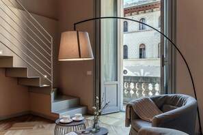 A modern interior with a staircase, a sofa, a coffee table, and a lamp. - 01 Cardinale Visconti - My Home In Como (Como)
