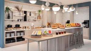 A modern kitchen with wooden shelves, a marble backsplash, and hanging pendant lights. - Fairfield By Marriott Copenhagen Nordhavn (Copenhagen)