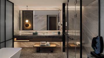 A modern bathroom with a large mirror, a bench, and a glass shower enclosure.