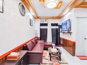 Exclusive Condo, 1 Bedroom | Living room | 49-inch Smart TV with digital channels, Netflix, streaming services - RB Modern Condos (Zamboanga)