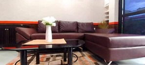 Exclusive Condo, 1 Bedroom | Living room | 49-inch Smart TV with digital channels, Netflix, streaming services - RB Modern Condos (Zamboanga)