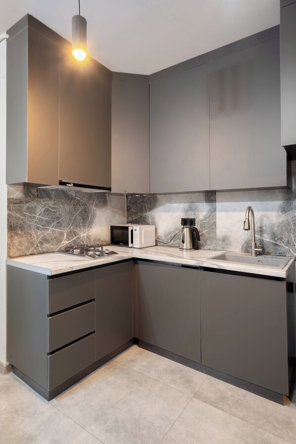 Fridge, microwave, stovetop, coffee/tea maker