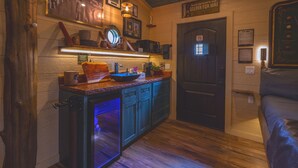 A compact kitchen with a microwave, coffee maker, and a small sink. - Luxury Treehouse | Golf + Smoky Mountain Views | Slide | Sleeps 6 (Sevierville)
