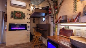 A cozy interior with a fireplace, wooden furniture, and a rustic decor.