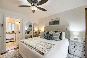 A bedroom with a bed, bedside tables, a ceiling fan, a window with blinds, a mirror, and a painting on the wall. - 37c Hidden Creek Mountain Getaway! 3 Bedroom Condo by RedAwning (Park City)