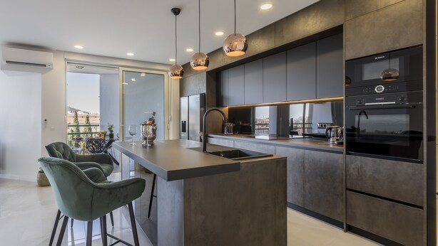 A modern kitchen with a central island, bar stools, and a Bosch oven. - Carmen - 2 Bedroom Apartment - Downtown (Split)