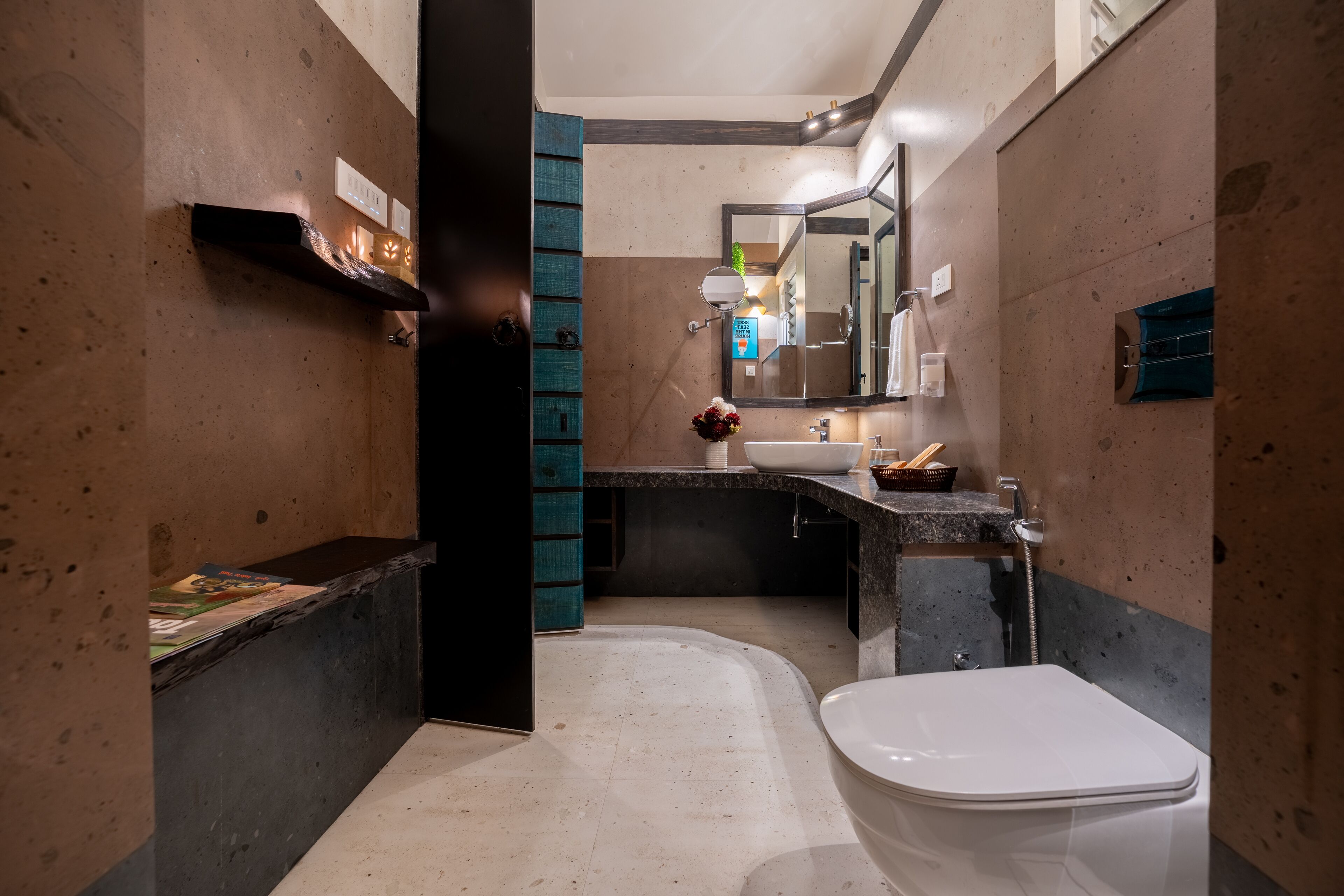 A modern bathroom with a white toilet, a sink with a mirror, and a towel rack.