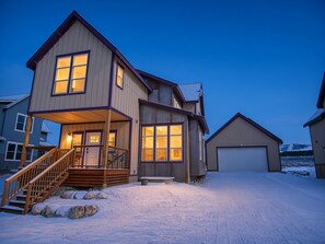 A two-story house with a porch and a garage.