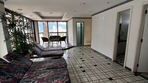 A spacious living area with a tiled floor, a sofa set, a dining table, and chairs. - Flat Ipanema - Vieira Souto 500 (Rio de Janeiro)