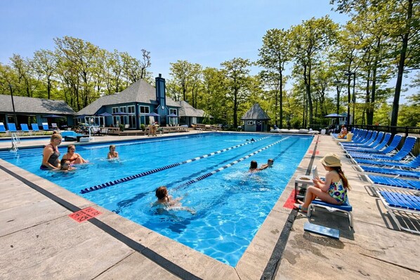 A swimming pool with lanes, lounge chairs, and a covered area with umbrellas. - Pool Access, Pet Friendly w/Pond View & Fire Pit (Hidden Valley)