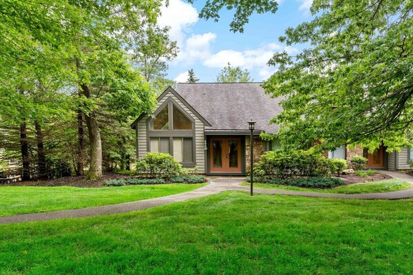 A two-story house with a gabled roof, a front porch, and a well-maintained lawn. - Pool Access, Pet Friendly w/Pond View & Fire Pit (Hidden Valley)