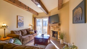 A cozy living room with a brown leather sofa, a wooden coffee table, and a fireplace. - 2 Bd 1.5 Ba Condo close to main street in Frisco, CO! (Frisco)
