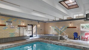 An indoor swimming pool with a no lifeguard warning sign, a hot tub, and a staircase leading to an outdoor area. - 2 Bd 1.5 Ba Condo close to main street in Frisco, CO! (Frisco)