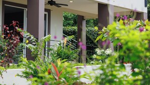 A multi-story building with balconies, a covered outdoor area, and lush greenery. - 6 room villa with rooftop terrace in Playa Coyote, Six room villa with pool, bar, and restaurant. Oc (San Francisco de Coyote)