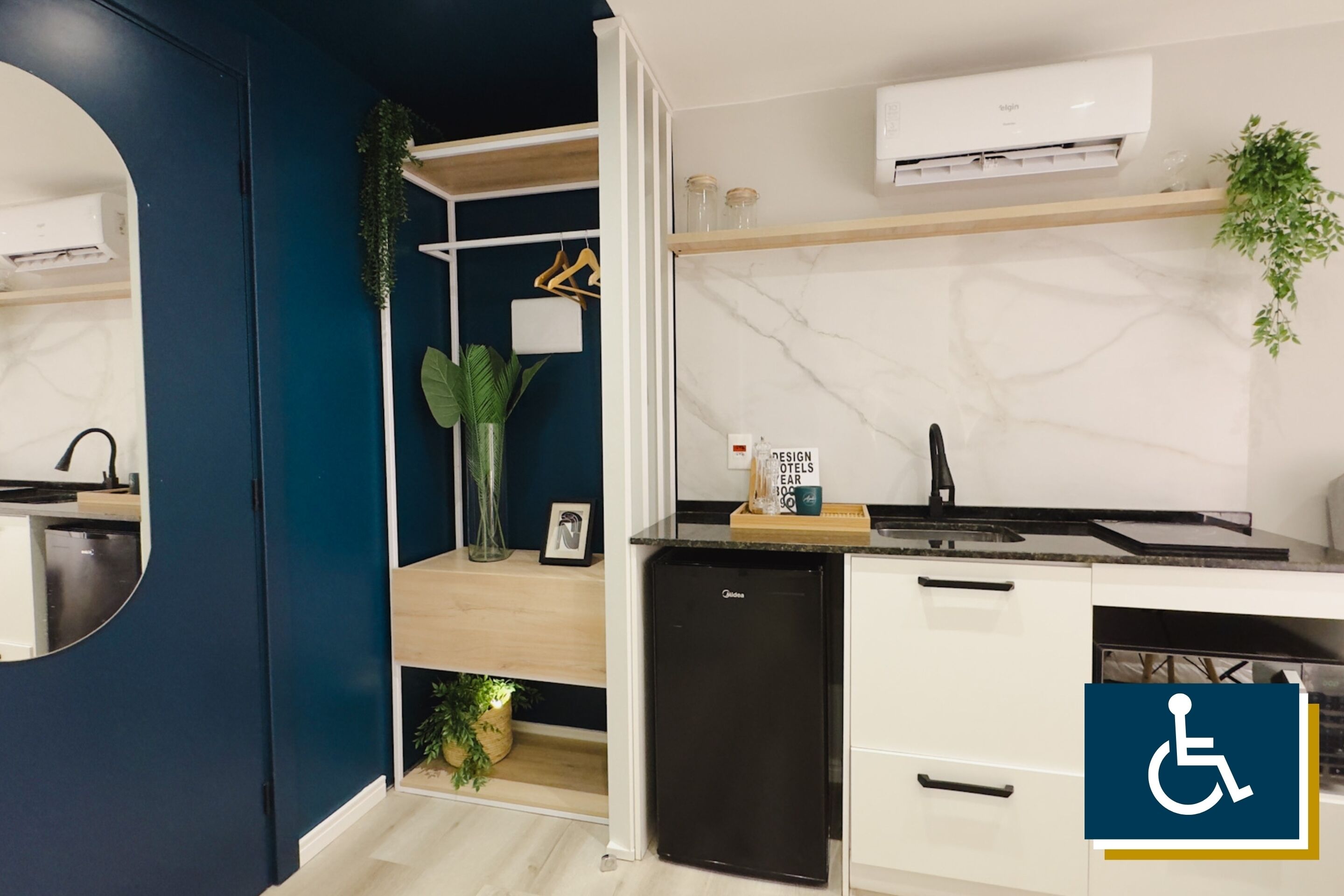 A modern kitchen with a built-in dishwasher, a marble backsplash, and a small refrigerator.
