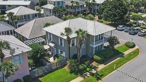A residential area with multiple two-story houses, each with a flat roof and a balcony.