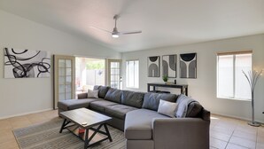 A modern living room with a sectional sofa, a coffee table, and a ceiling fan. - Golf Course View! Dog-friendly Retreat in Glendale (Glendale)
