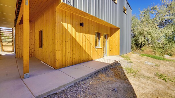 A modern building with a wooden facade and a grey metal exterior. - Unique Grand Junction Guest Suite w/ Gas Fire Pit! (Grand Junction)