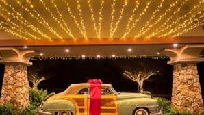 A vintage car with a red ribbon under a canopy of string lights. - Spectacular Ocean View - Heated 80° Pool - Seascape (Aptos)